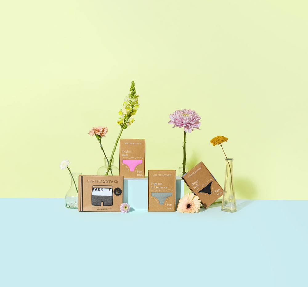 Stripe & Stare underwear in recycled packaging surrounded by flowers