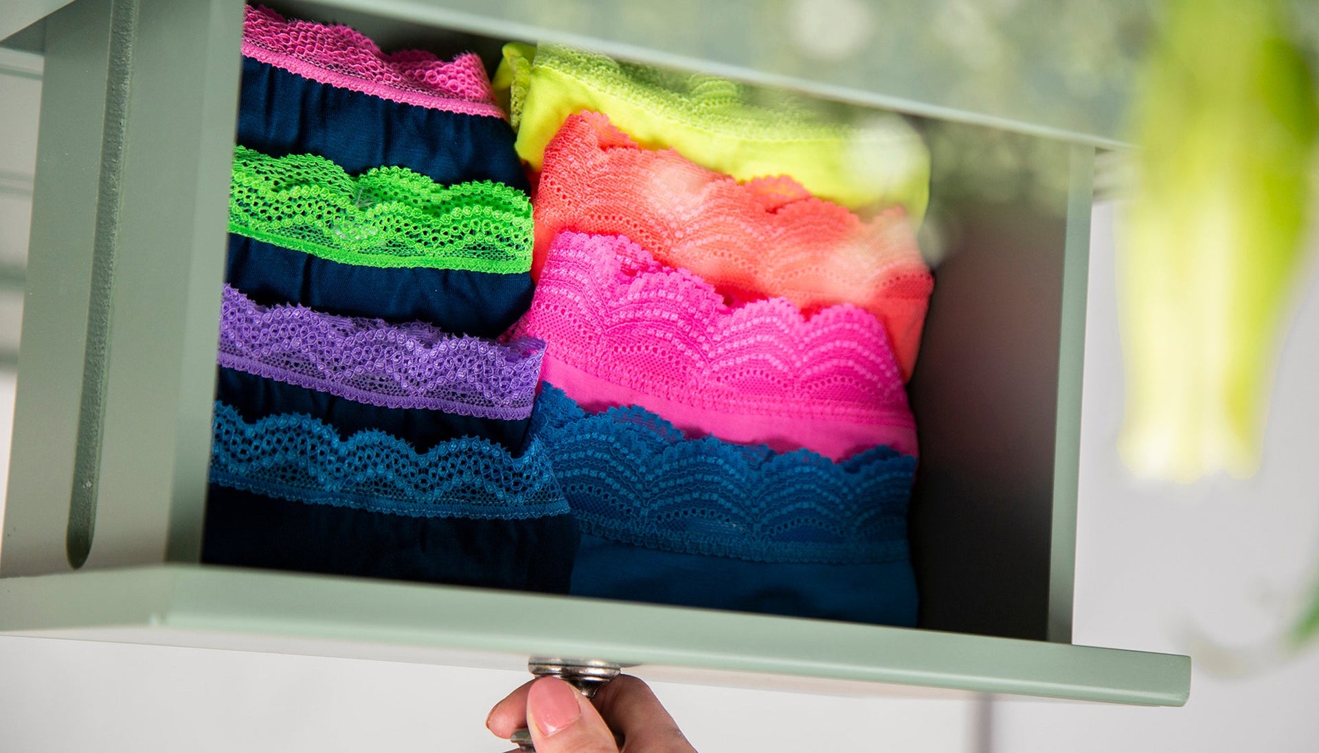 An open drawer filled with folded briefs