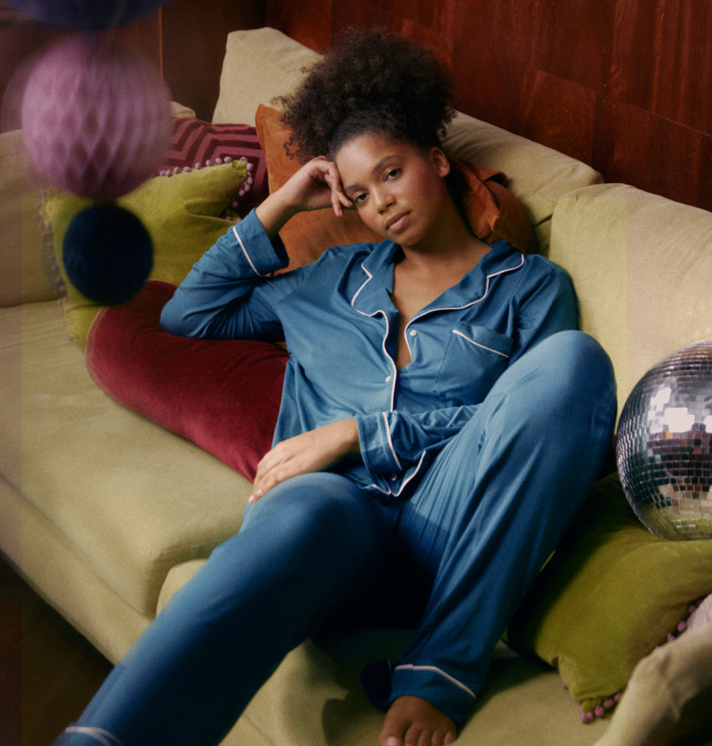 model wearing midnight pyjama on sofa